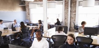 View Of Staff In Busy Customer Service Department